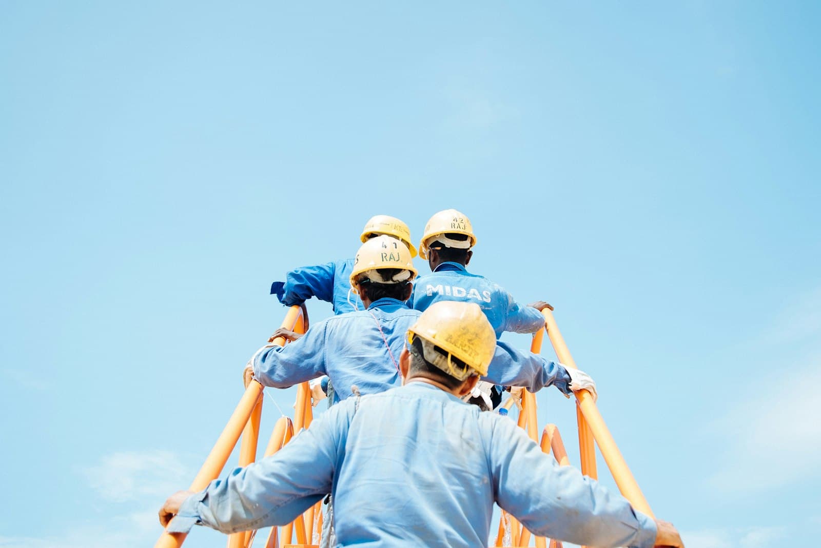 Mining crew climbing site stairs in high-vis